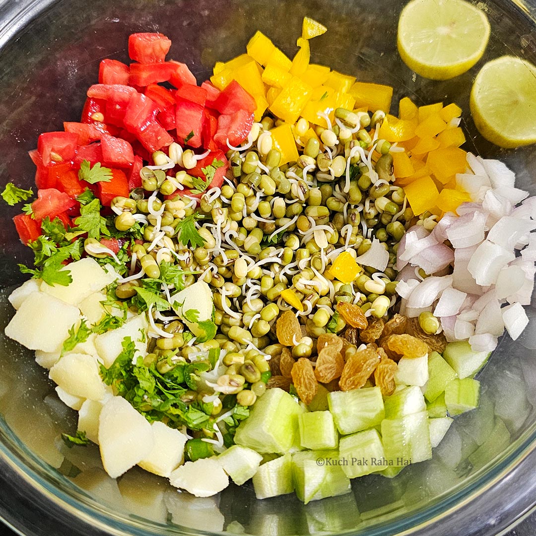 Mixing sprouts with veggies and seasoning.