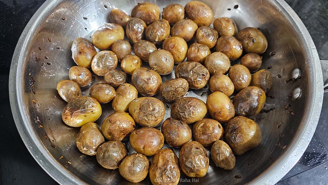 Pan fried small potatoes in pan.