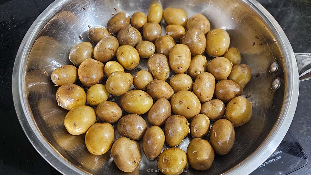 Adding mini potatoes to hot oil.