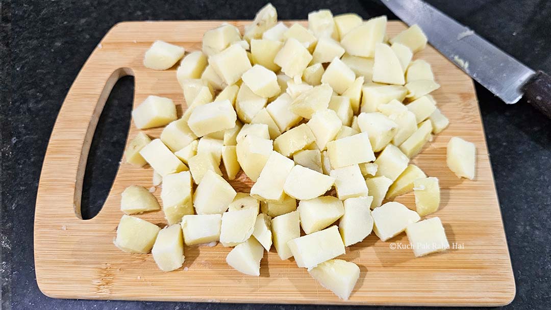 Chopping potato into small cubes.