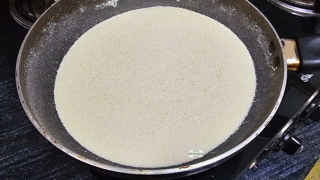 Roasting rava in a pan.