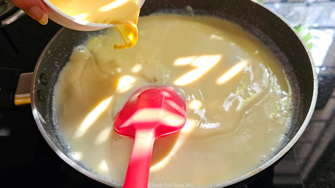 Adding custard milk to hot milk.