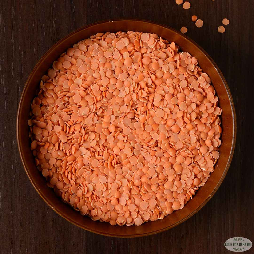 Uncooked orange or red lentils in a bowl.
