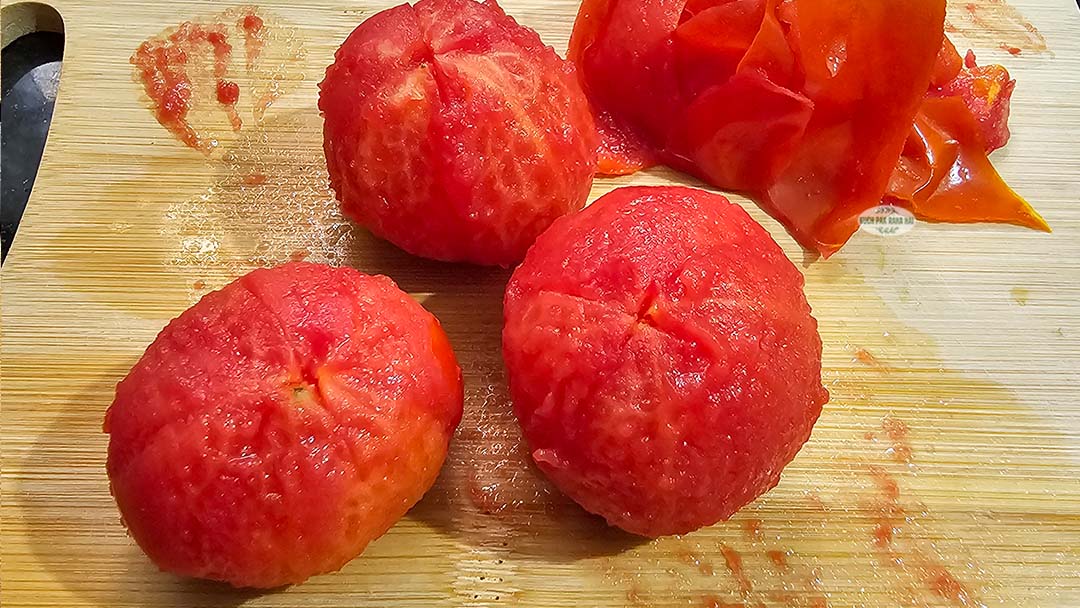 Peeling blanched tomatoes.