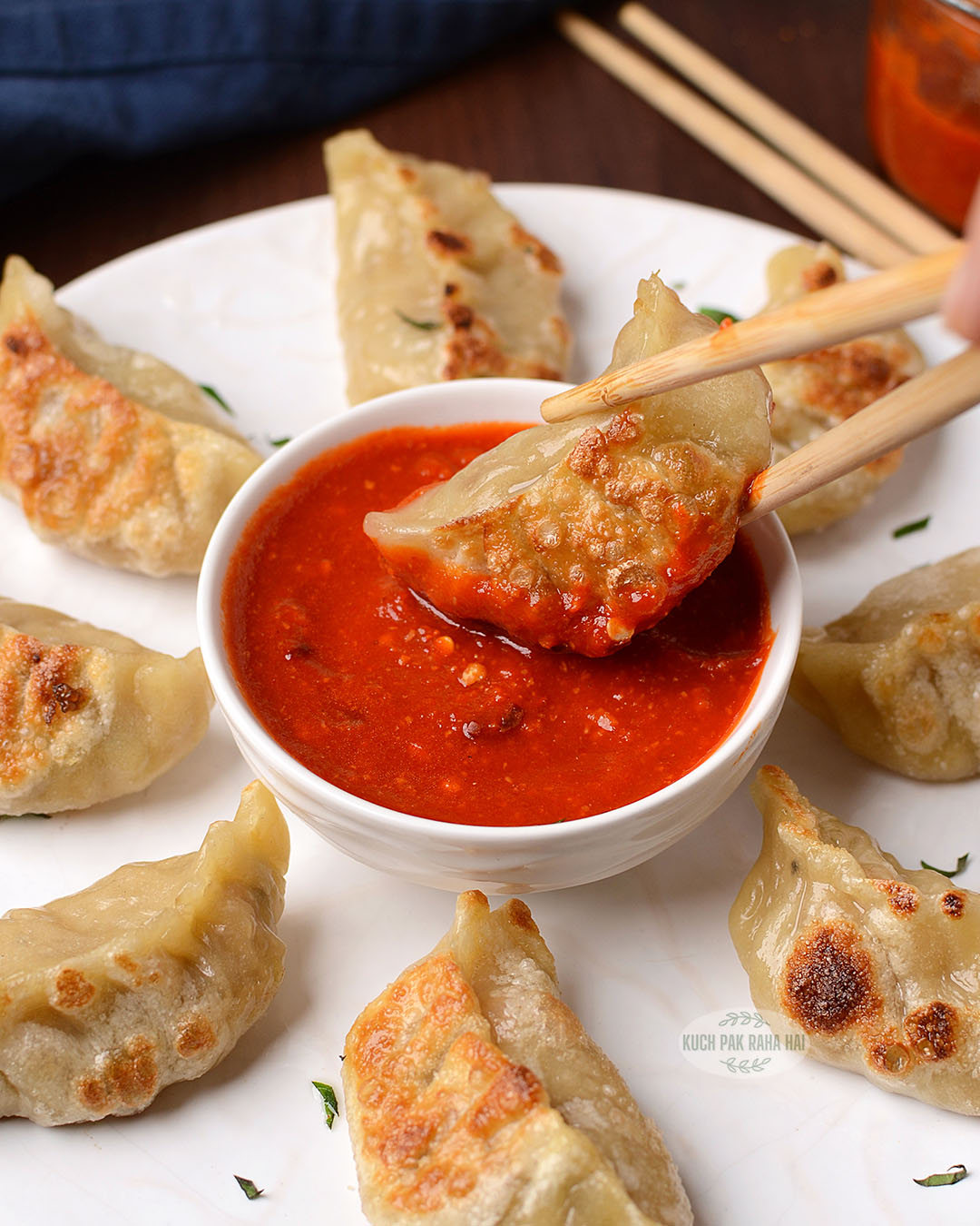 Spicy red chutney served with pan fried momos.