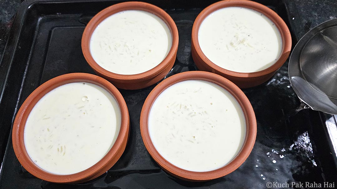 Filling baking tray with water.