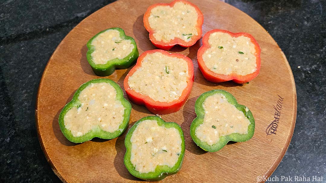 Stuffing capsicum with potato mixture.