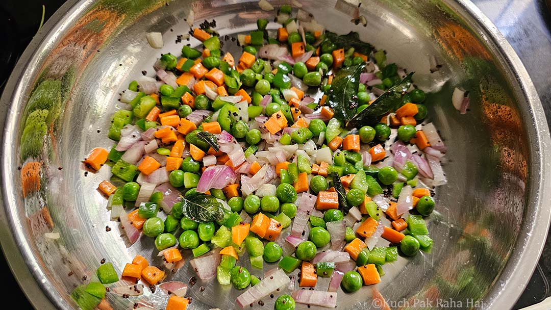 Sautéing onion and bell peppers.