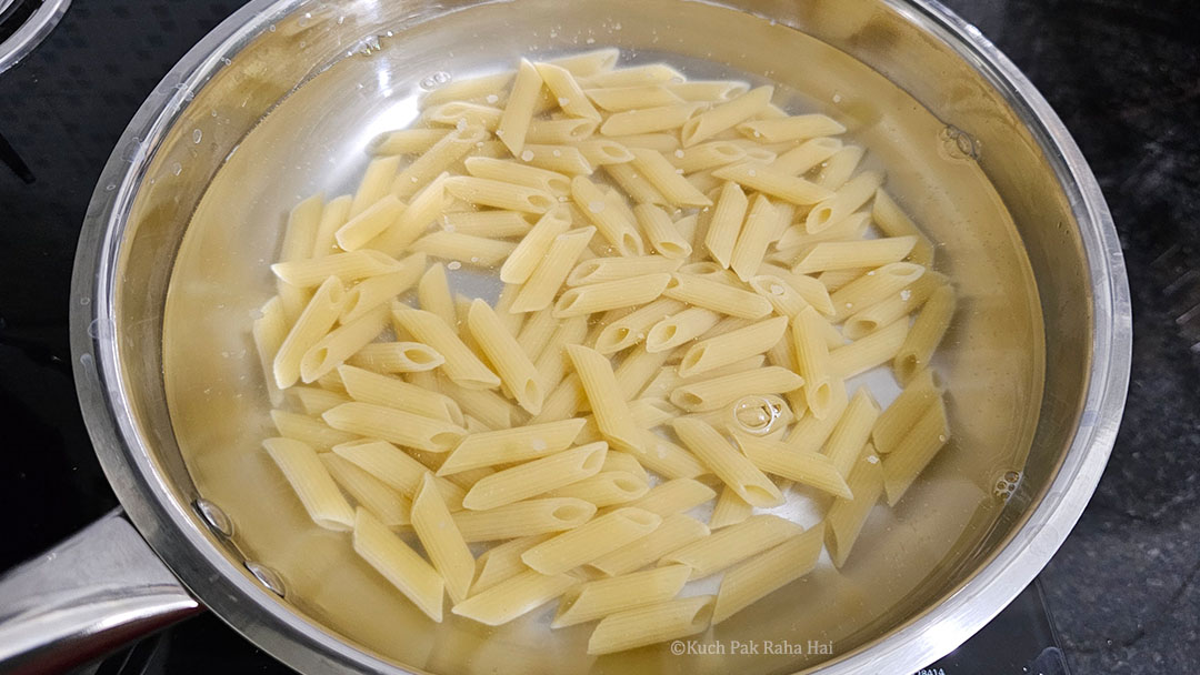 Boiling penne pasta.