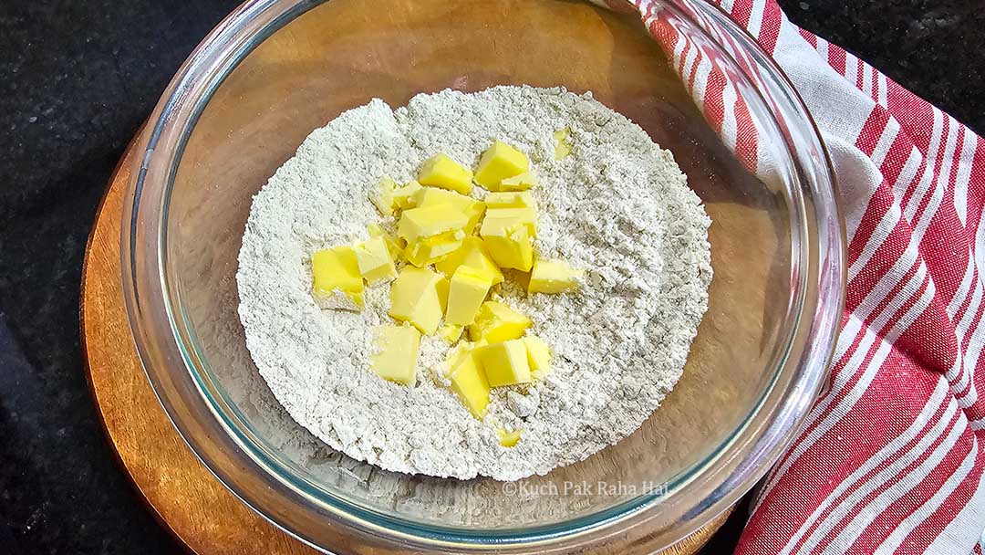 Adding cold butter to flour.