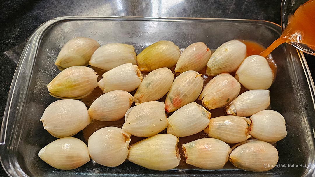 Arranging stuffed onions in a baking dish.