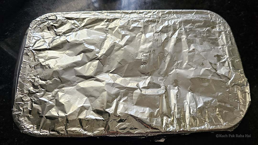 Baking dish covered with aluminium foil.