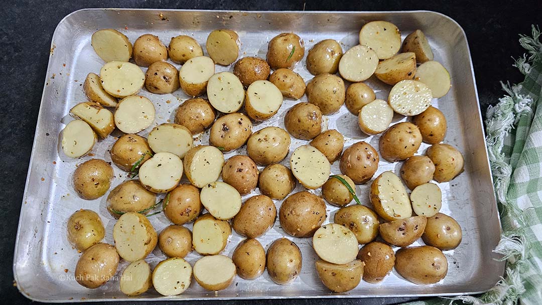 Tossing potatoes in herbed oil mixture.