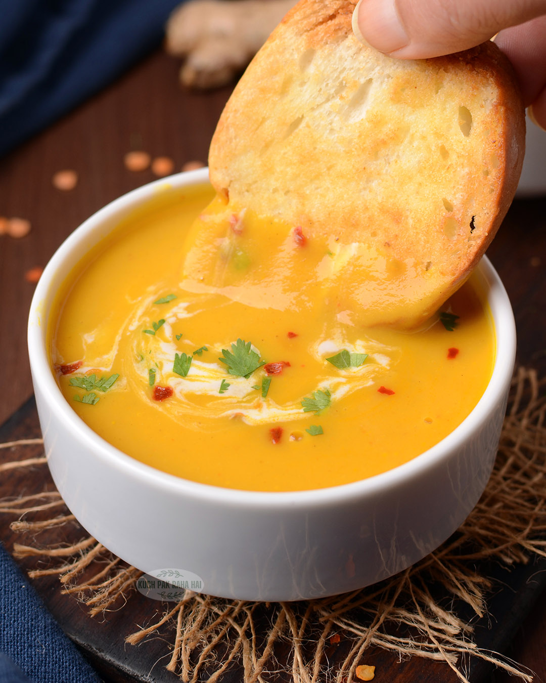 Carrot and lentil soup served with toasted crusty bread.