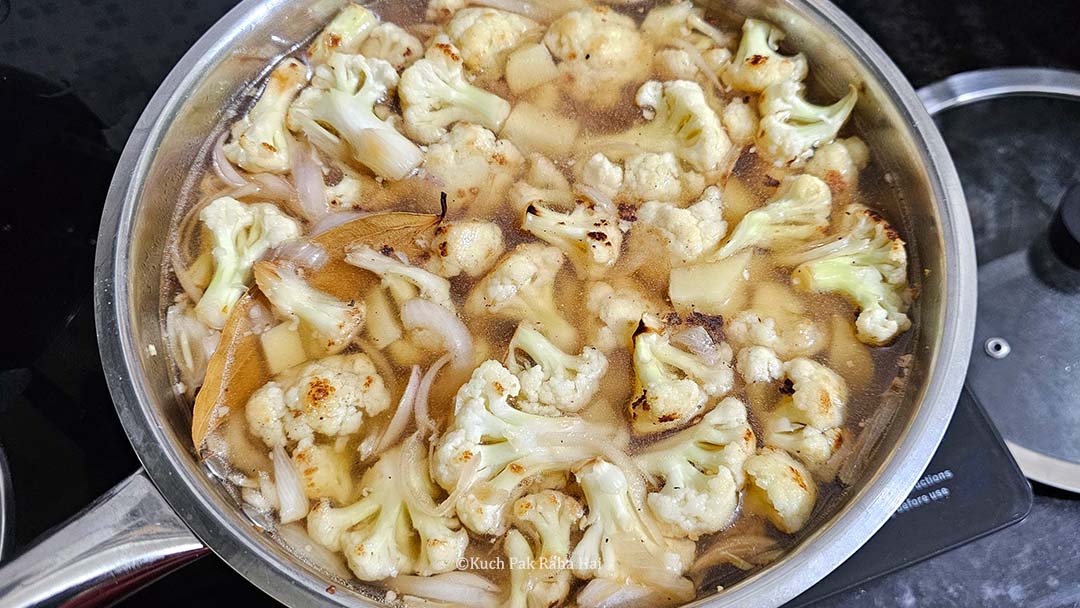 Cooking cauliflower potatoes in veg stock.