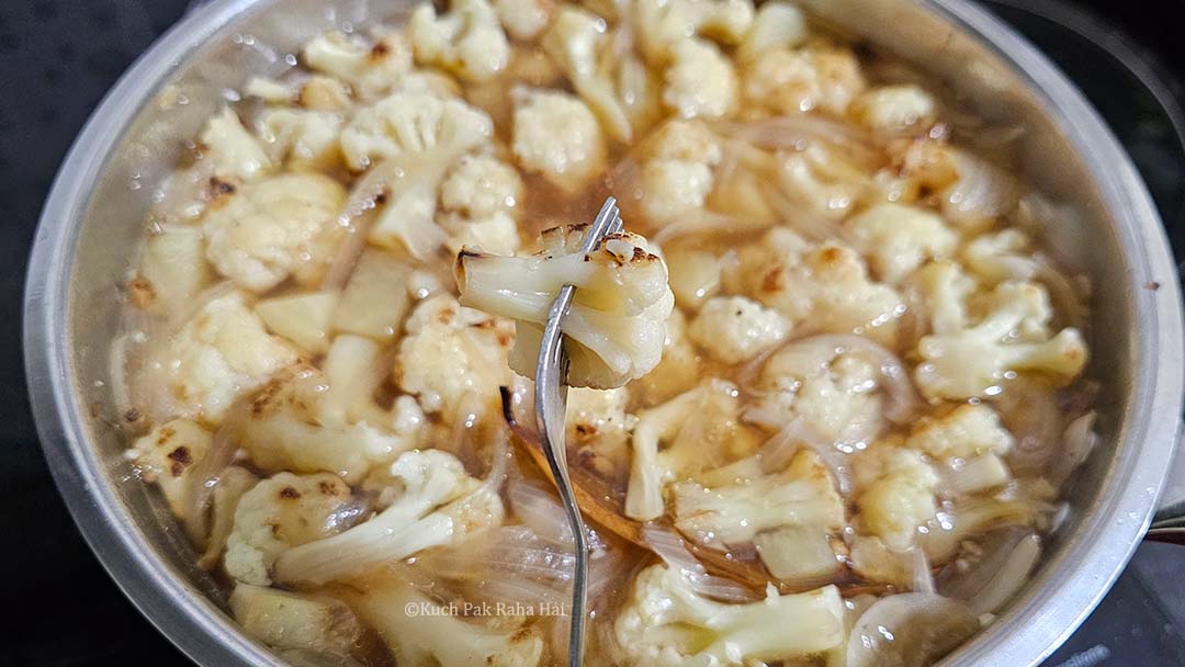 Checking if cauliflower is cooked.