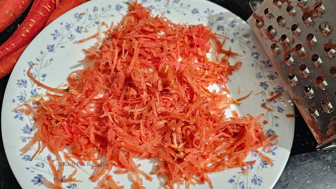 Grating carrots using a grater.