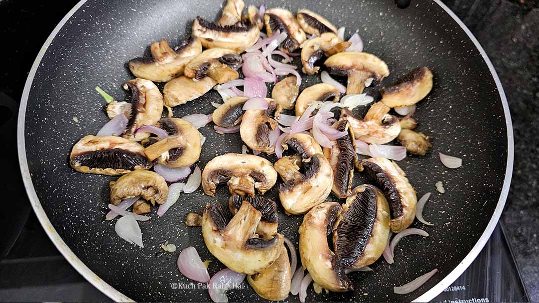 Adding mushrooms to pan.