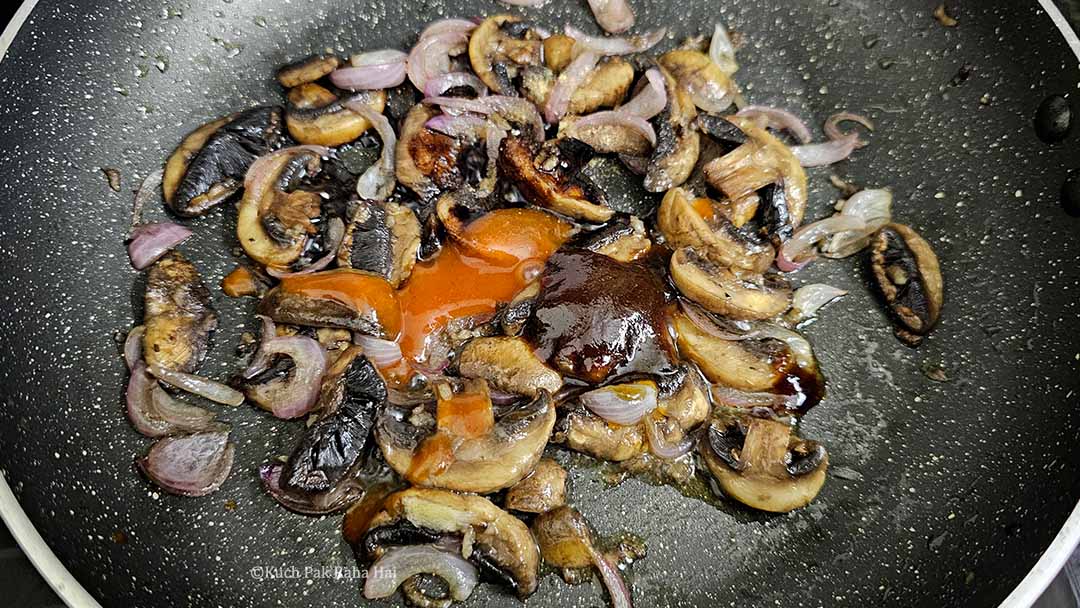 Adding sauces to sautéed mushrooms.